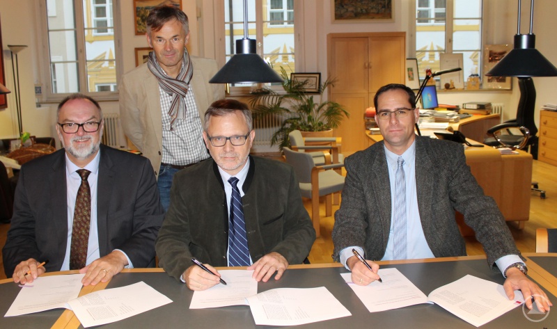 Oberbürgermeister Jürgen Dupper (von links) unterzeichnet mit Klaus Fiedler vom Haus- und Grundbesitzerverein Passau und Lothar Kühnemann vom Mieterverein Passau den neuen Mietspiegel im Beisein von Werner Lang (hinten), Referent für Wirtschaft und Arbeit, Passau Tourismus und Stadtmarketing.