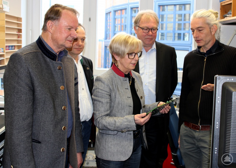 Der stellvertretende Landrat Willi Killinger (v.li.), Büroleiter Günther Weinberger und Landrätin Rita Röhrl zeigten sich beeindruckt von der Entwicklungsabteilung die ihnen vom AVM-Geschäftsführer Vertrieb Ulrich Müller-Albring und Roderick Bell, Leiter der Hardware-Entwicklung, gezeigt wurde.