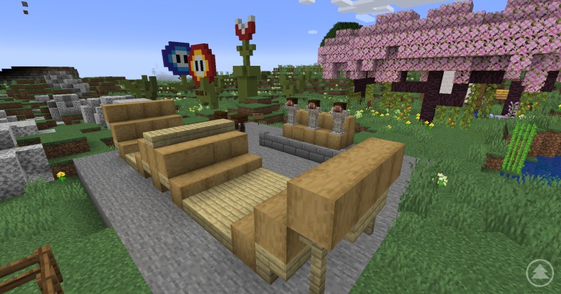 Kreativ gestalteter Bike-Park mit Zuschauertribüne und Gaming-Elementen – Action und Spaß inklusive. Minecraft-Darstellung eines Bike-Parks mit Tribüne, Blumenwiese und pixeligen Super-Mario-Elementen im Hintergrund.