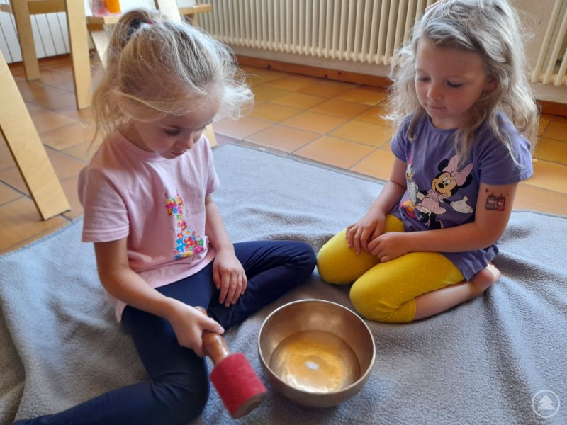 Diese beiden Mädchen probieren Übungen mit der Klangschale aus.