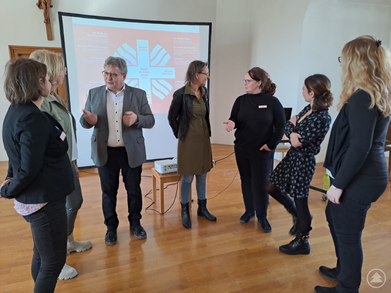 Miteinander Caritas leben. Caritasdirektorin Mag.a (FH) Andrea Anderlik, MSc (re.) und Diakon Konrad Niederländer tauschen sich mit neuen Mitarbeiter*innen aus.