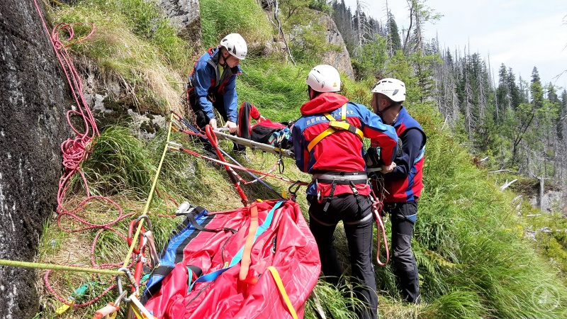 Patientin wird auf der Schaufeltrage zur Gebirgstrage gebracht