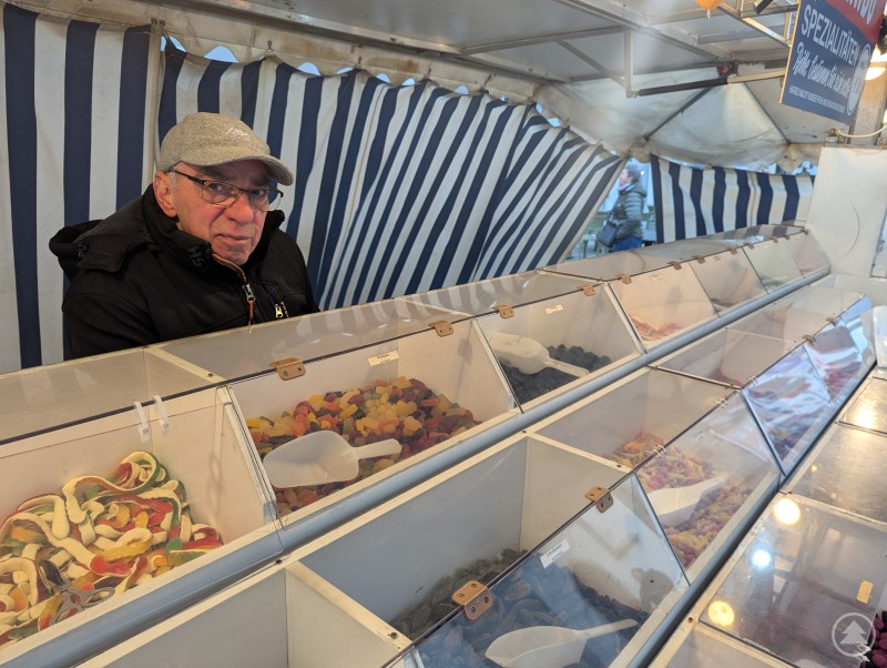 Süße und herzhafte Leckereien gab es beim Herbstmarkt reichlich zu naschen. Auch die lokalen Restaurants luden zum Genuss ein. Händler sitzt hinter seinem Süßigkeitenstand