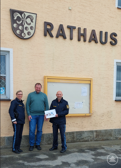 Polizeioberrätin Ingrid Grötzinger (PI Freyung) und Polizeihauptkommissar Georg Binder (PSt Waldkirchen) überreichen Bürgermeister Roland Freund den Sicherheitsbericht.