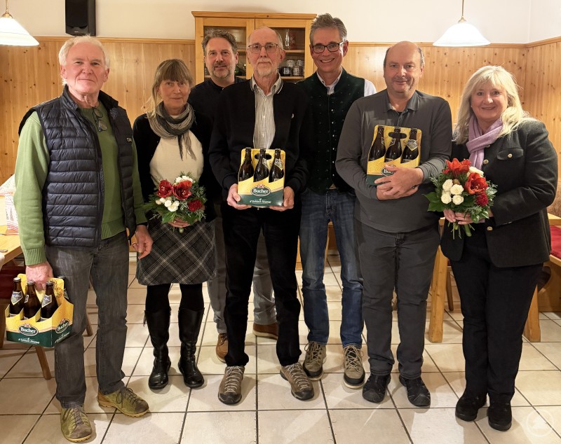 Der Vorsitzende des Waldvereins Grafenau, Hans Ulrich Wiedemann (5.v.l.), bedankte sich bei seinen Vorstandsmitgliedern Wanderwart Karl Graf (v.l.), Schriftführerin Rita Dageförde, Hüttenwart Rainer Blöchinger, Kassier Richard Aigner, stellvertretenden Vorsitzenden Josef Rohrhofer und Kulturwartin Roswitha Prasser mit Blumen und einem Sixpack Lusenbier. Gruppenfoto mit den Vorstandsmitgliedern des Waldvereins Grafenau in einem Gasthof. Die Geehrten stehen nebeneinander und halten Blumen sowie Sixpacks Lusenbier in den Händen.