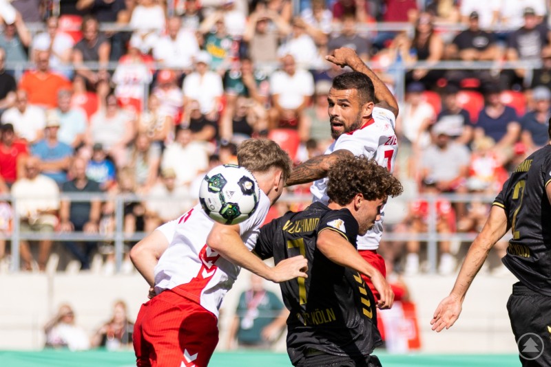 Umkämpfte Luftduelle bestimmten die Schlussphase des Spiels. Kopfballduell im Strafraum, Spieler von Regensburg und Köln springen hoch zum Ball.